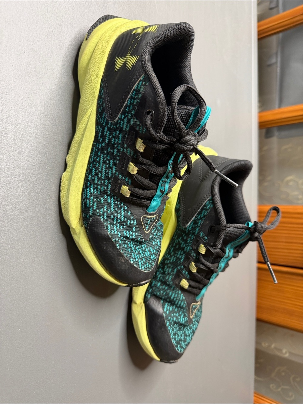 Kid’s Under Armour Black, Yellow, and Teal Athletic Shoes. Size: 4